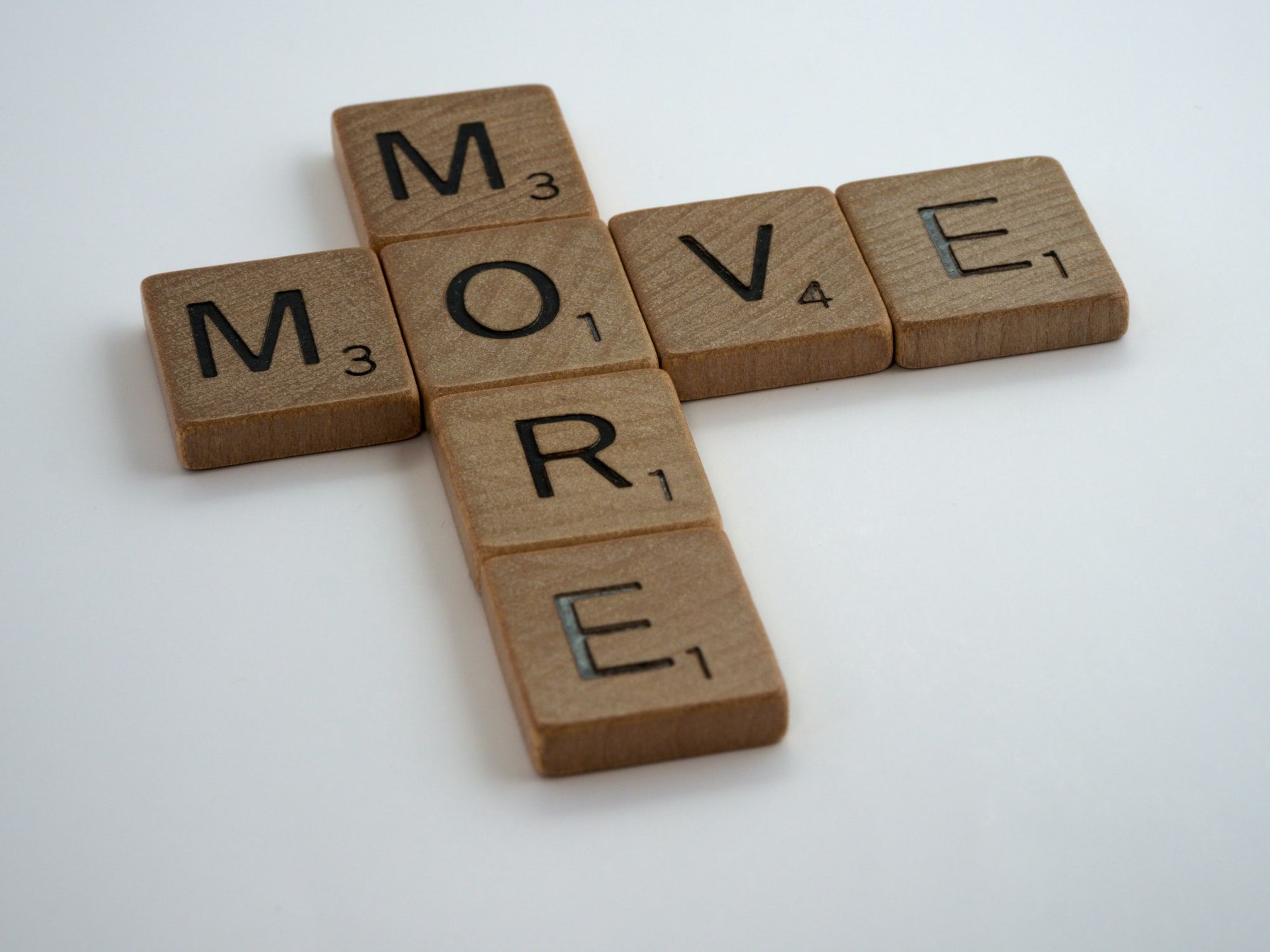scrabble, scrabble pieces, lettering, letters, wood, scrabble tiles, white background, words, quote, move more, move, more, exercise, health, healthy lifestyle, step out, walk, get out of your seat, stop sitting, lazy, couch potato,

